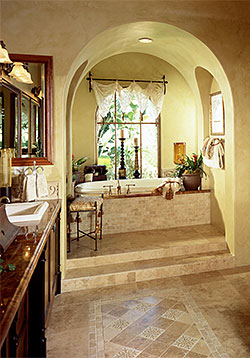 Beautifully tiled hallway between kitchen and living room with curved entranceway and more.